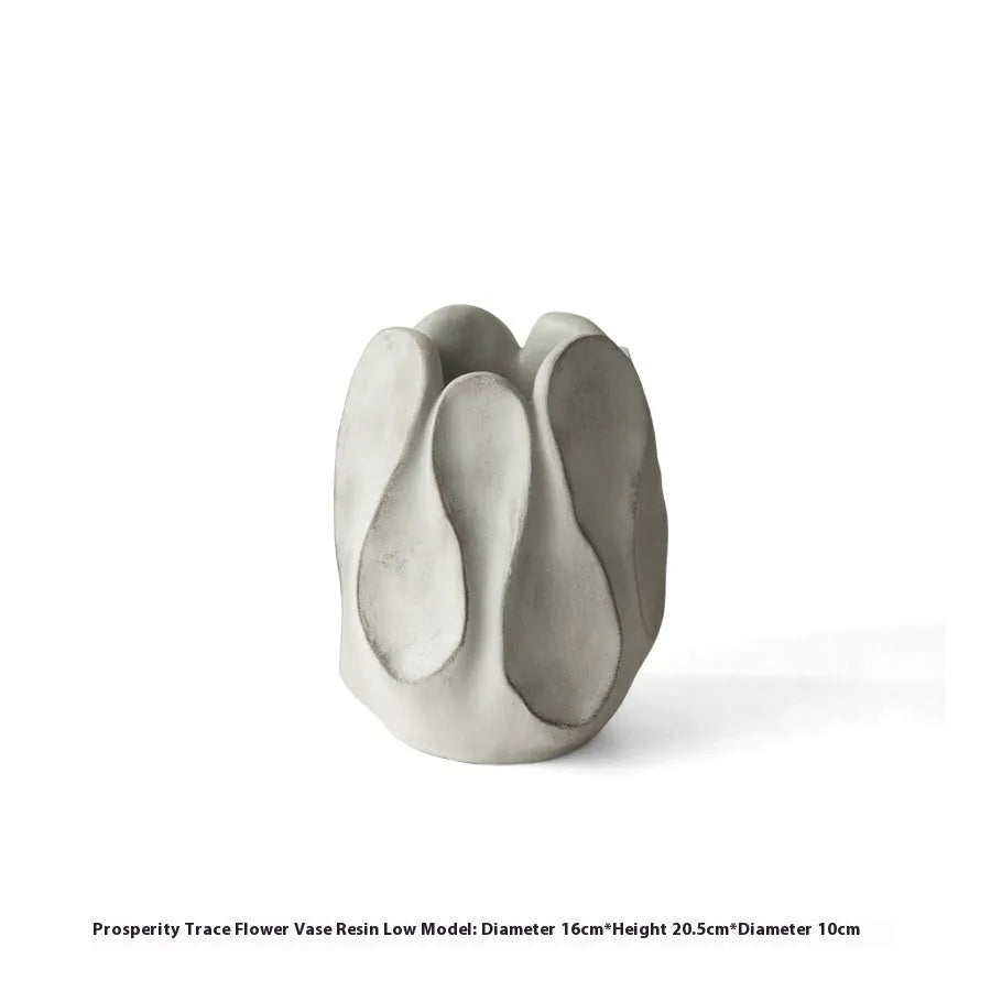 Irregular shaped ceramic art vase for flower arrangements on a desktop.