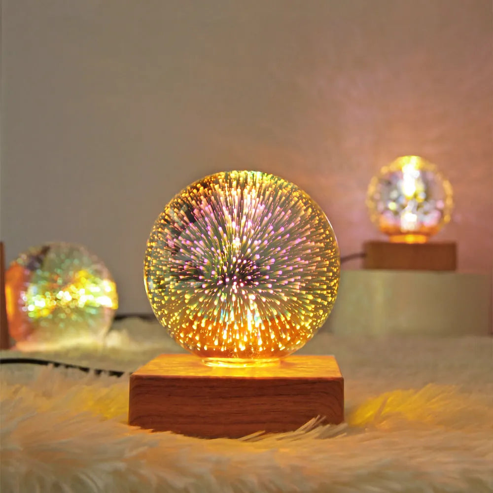 USB plug-in crystal ball LED night light showing fireworks design on a desk