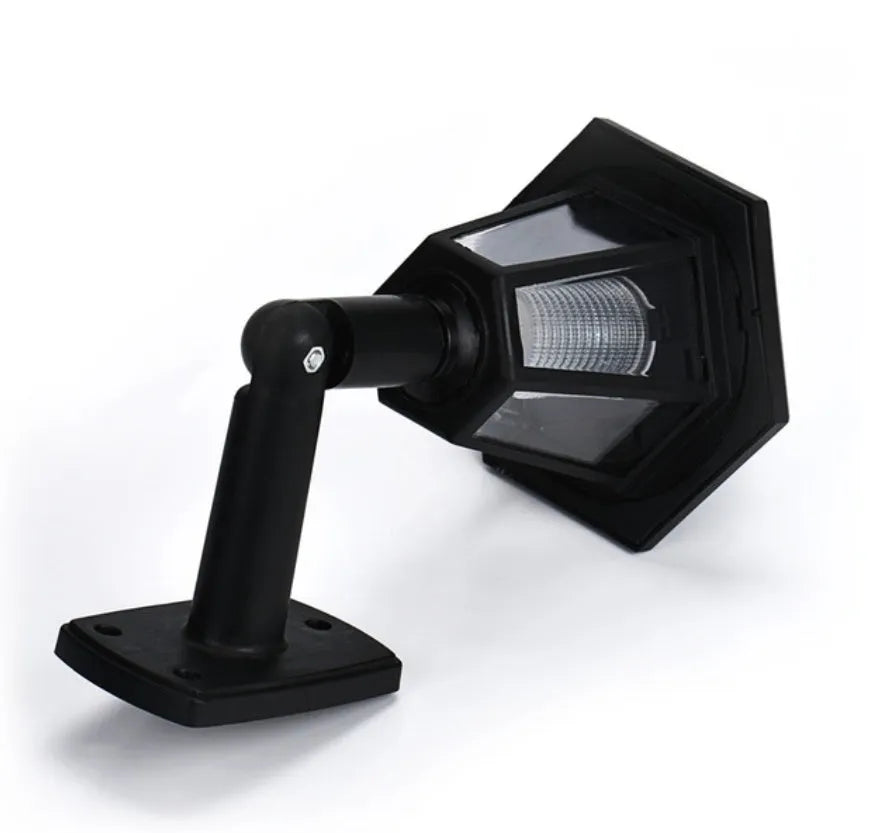 Black hexagonal solar-powered wall light with LED and solar panel for outdoor use