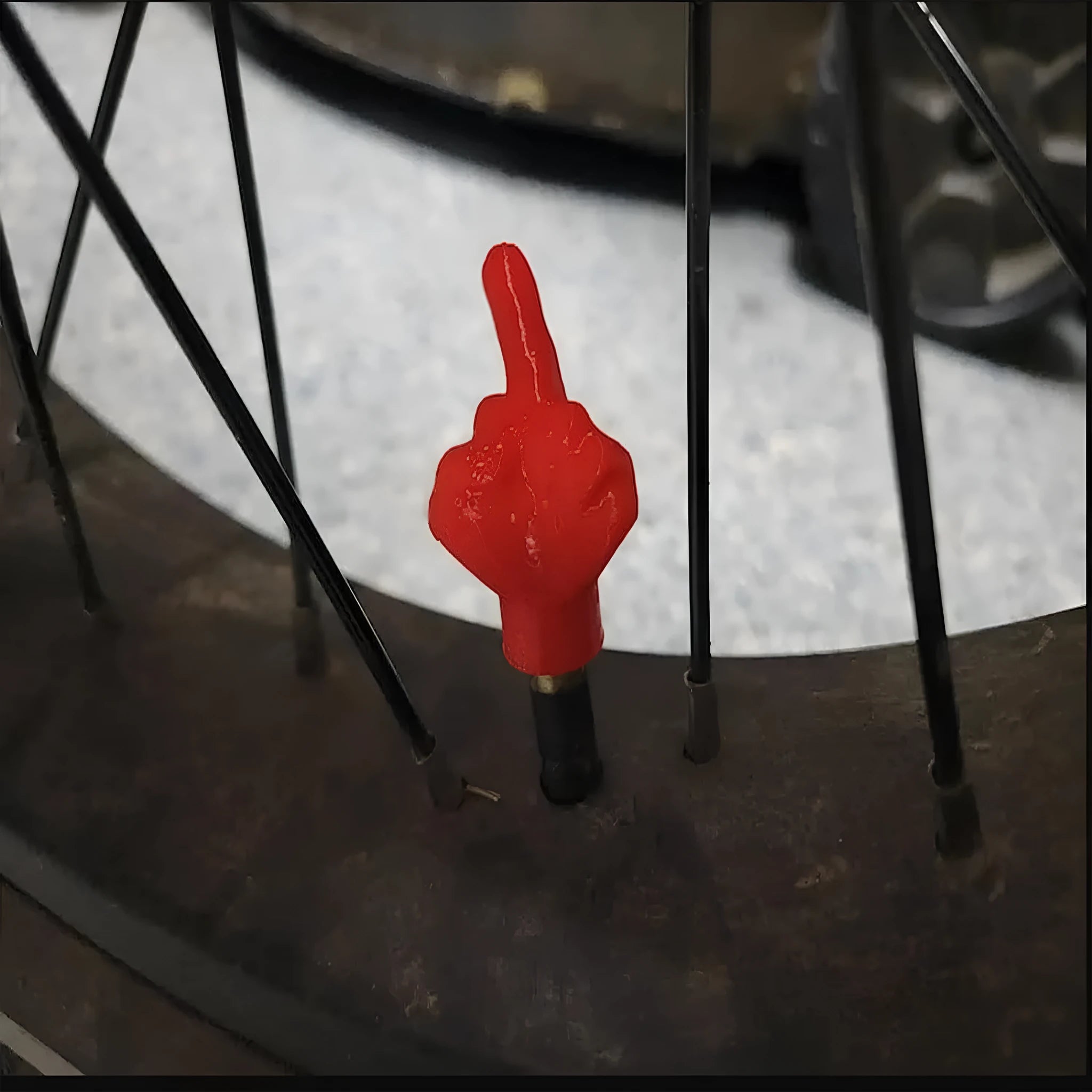 Four latex tyre valve caps showing two skin colour and two black pieces for car tyre protection