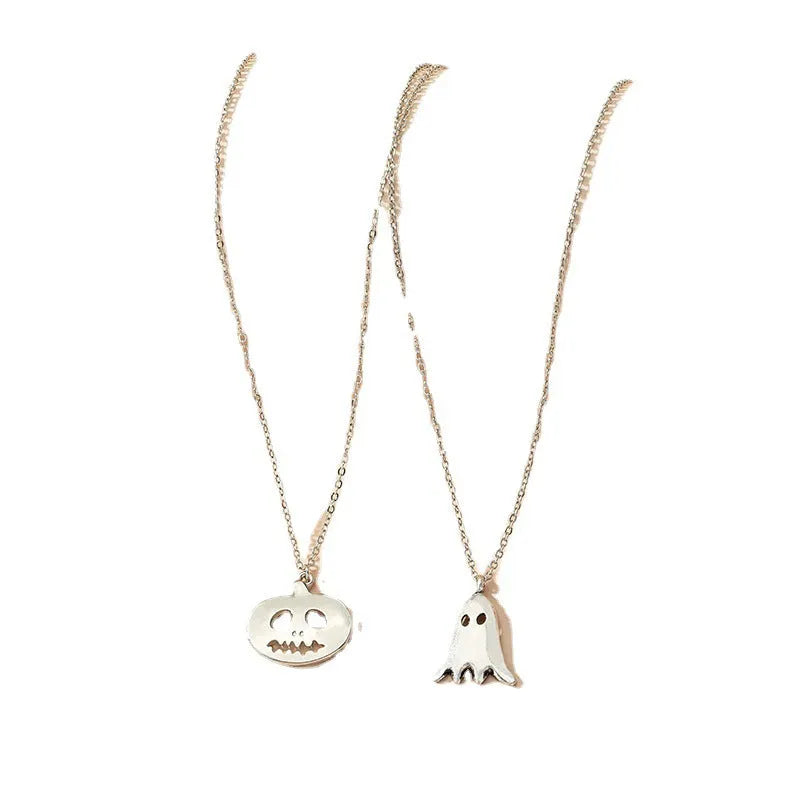 Two silver alloy pendant necklaces: one cartoon pumpkin and one cartoon ghost on a light background