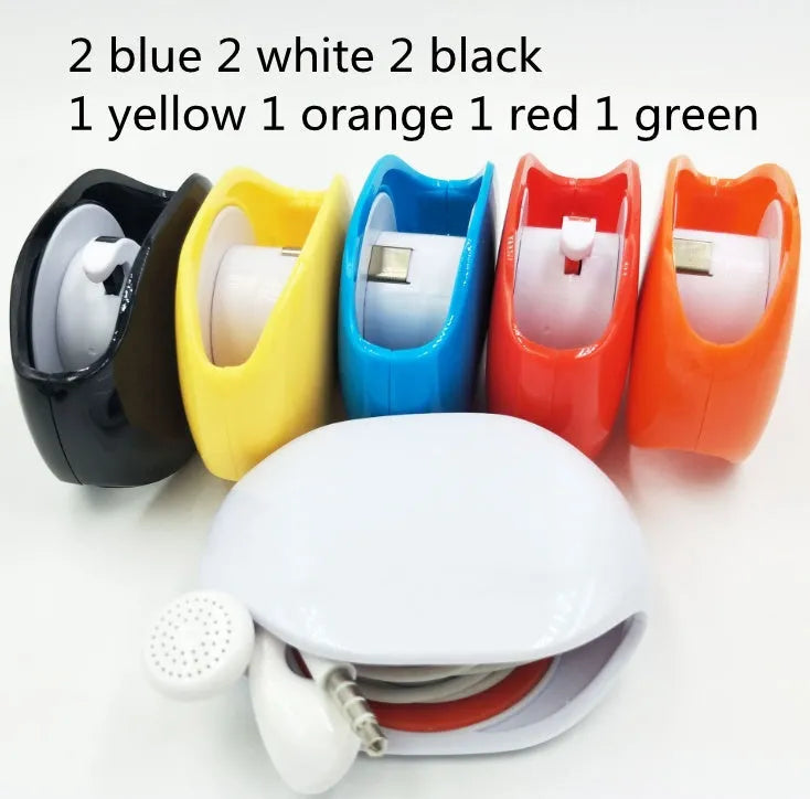 Automatic plastic cable winder retractor showing black, blue, and red units next to a coiled earphone cable.