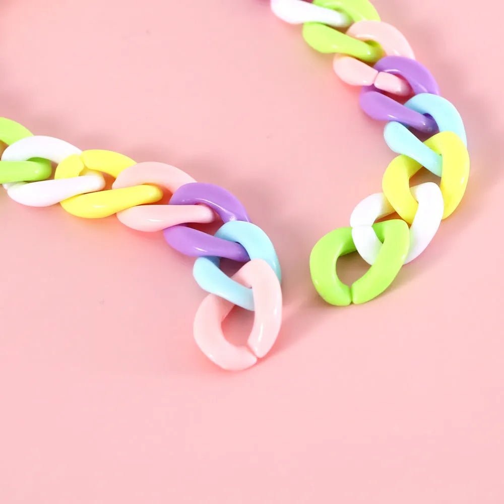 Adjustable plastic pet collar in macaron candy colours with chain detailing, shown with a buckle.