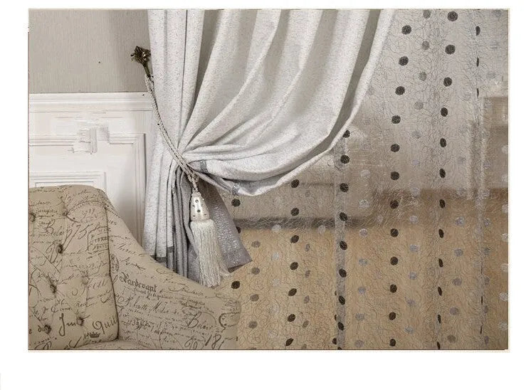 A simple blackout curtain panel hanging on a pole, demonstrating one of the hook, Korean hook, or ring attachment styles.