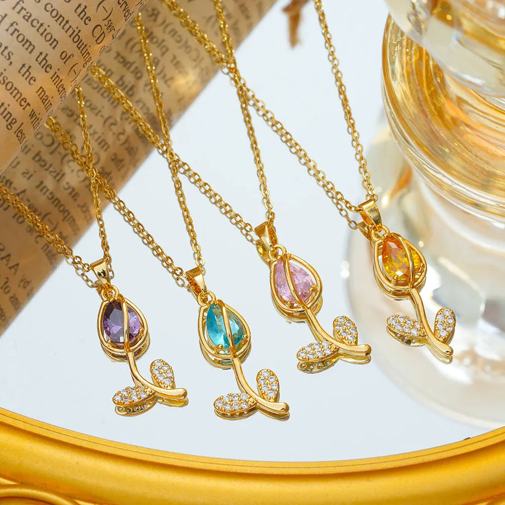 Gold tulip flower pendant necklace on an adjustable O-ring chain, showing electroplated finish.