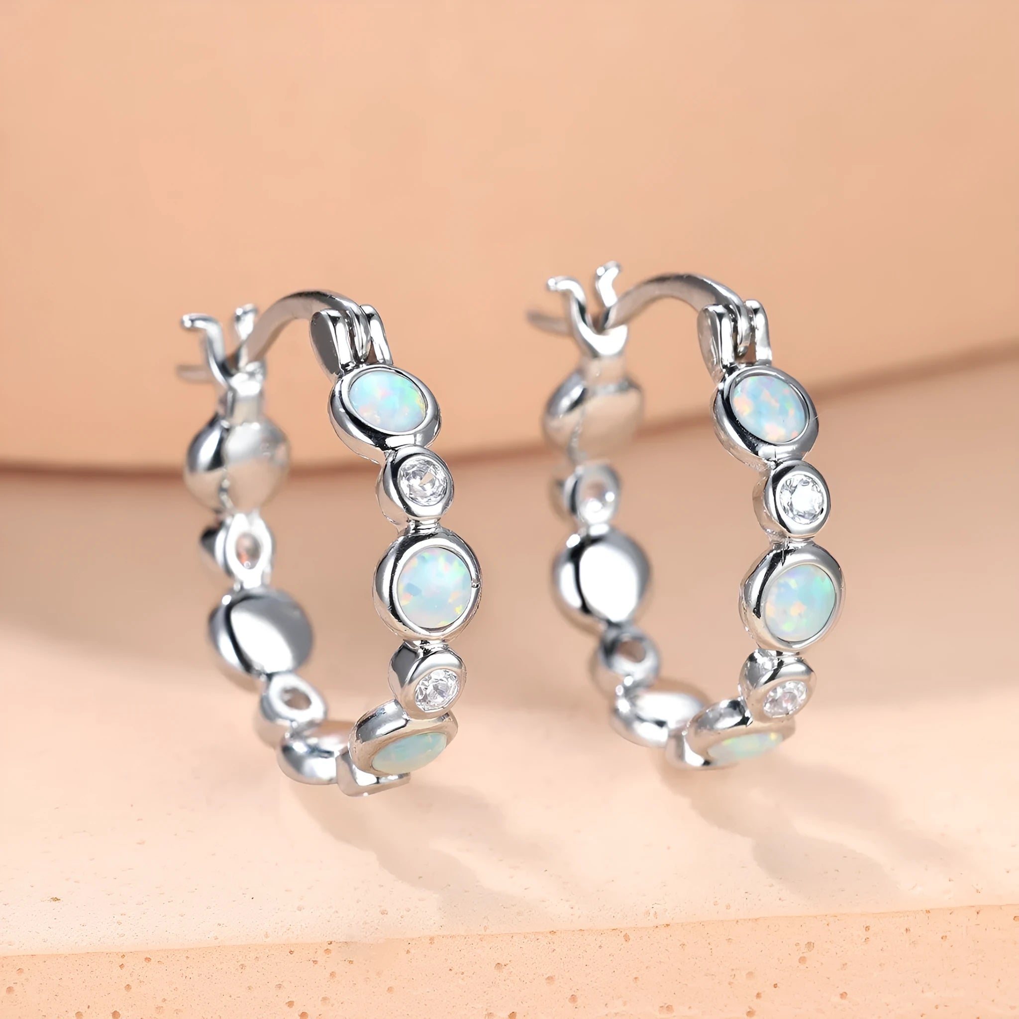 Round synthetic opal and cubic zirconia clip-on earrings in electroplated copper