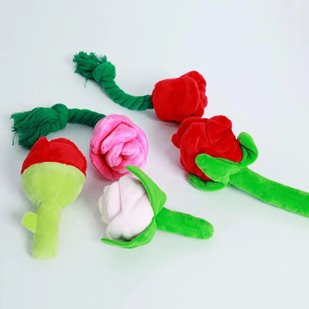 Plush pink rose flower dog chew toy with green leaf and a squeaker inside.