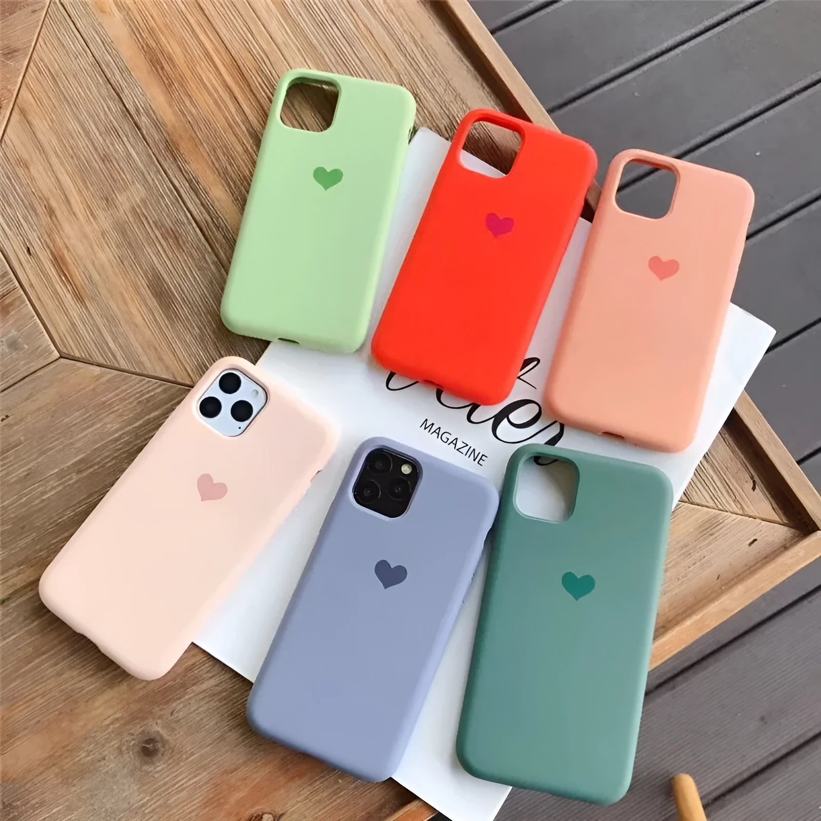 Solid-colour silicone phone case for iPhone, shown in dark green, flour, light green, light pink, purple, and red.