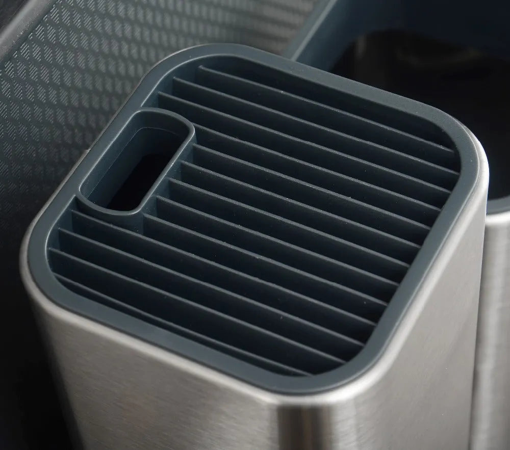 Black and white multifunctional kitchen tool holder with detachable bottom for storing knives and cutlery.