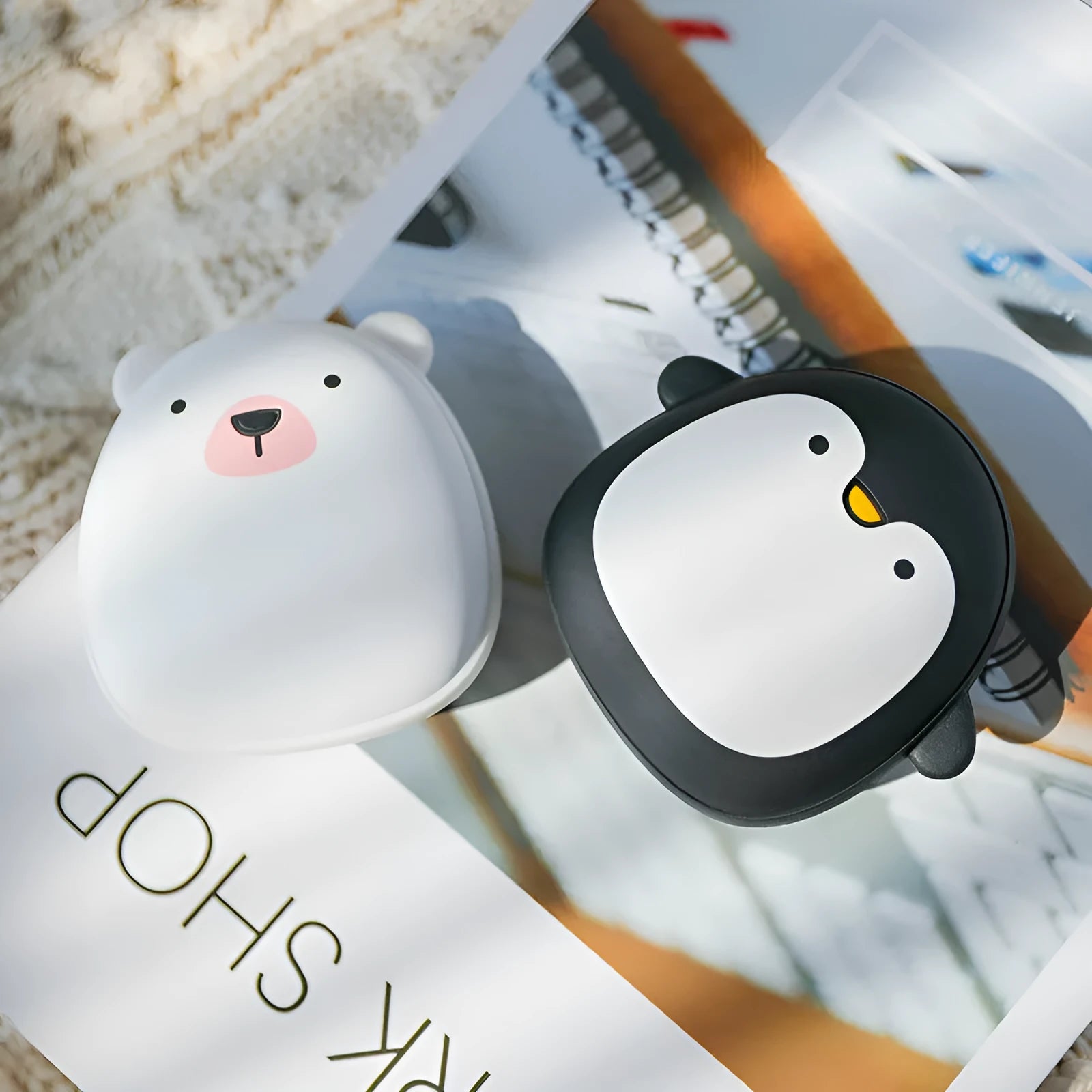Cartoon penguin polar bear USB rechargeable hand warmer and power bank unit.