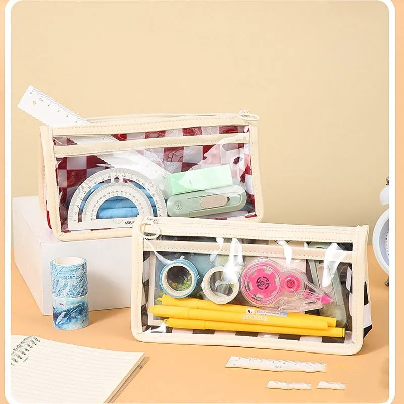 Clear PVC pencil case with black and white chessboard grid design, showing pens inside.