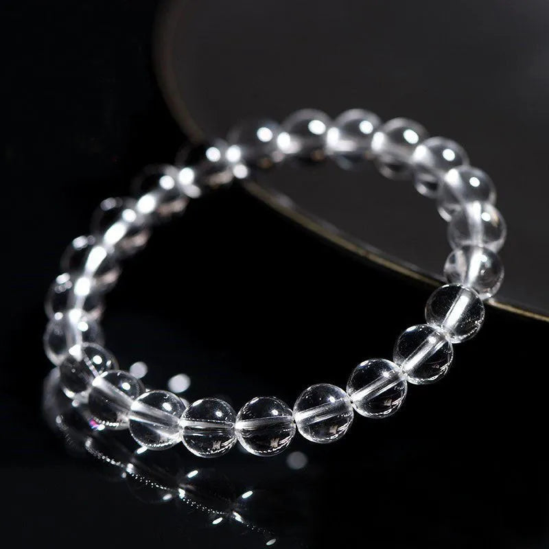 Natural Donghai white crystal round bead geometric bracelet on a wrist.