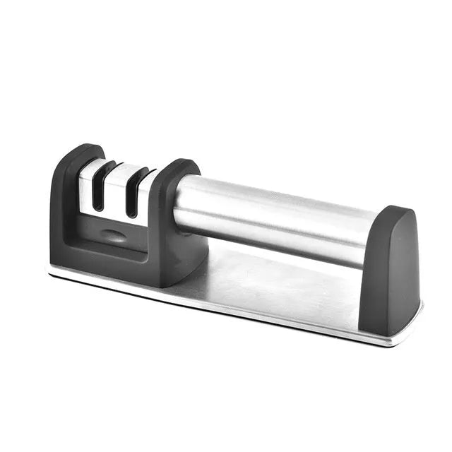Black multi-purpose kitchen sharpener with stainless steel holes for knives, scissors, and screwdrivers on a non-slip ABS plastic body.