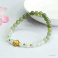 Hand-woven Chinese jade bracelet with water-gradient colour pattern and flower design