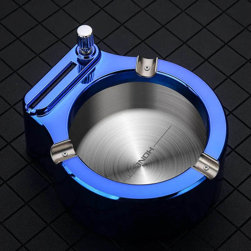 Large blue metal ashtray with integrated sliding stick permanent match lighter and three cigarette slots.