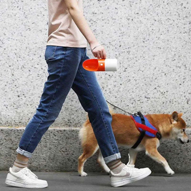 White and grey Moestar Rocket shaped pet water bottle with cup head and lock button.