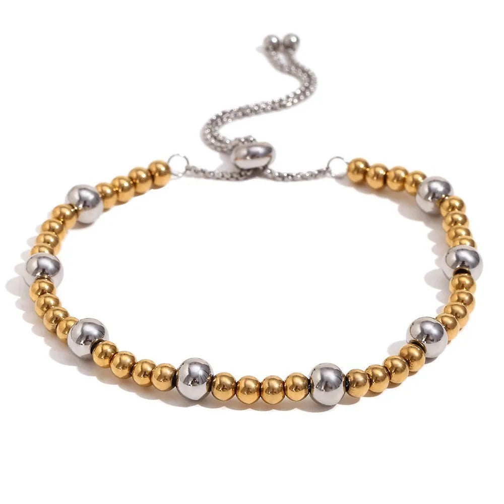 Gold geometric stainless steel jewellery set for women, showing earrings, necklace, and bracelet with electroplated finish.