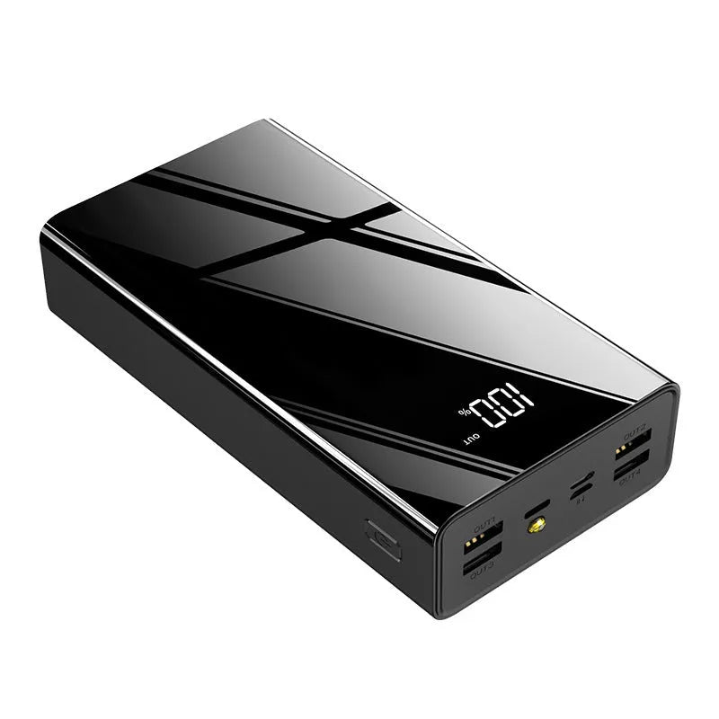 Large black 40000mAh power bank with LCD display showing battery percentage, placed next to a charging cable.