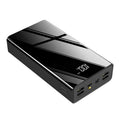 Large black 40000mAh power bank with LCD display showing battery percentage, placed next to a charging cable.
