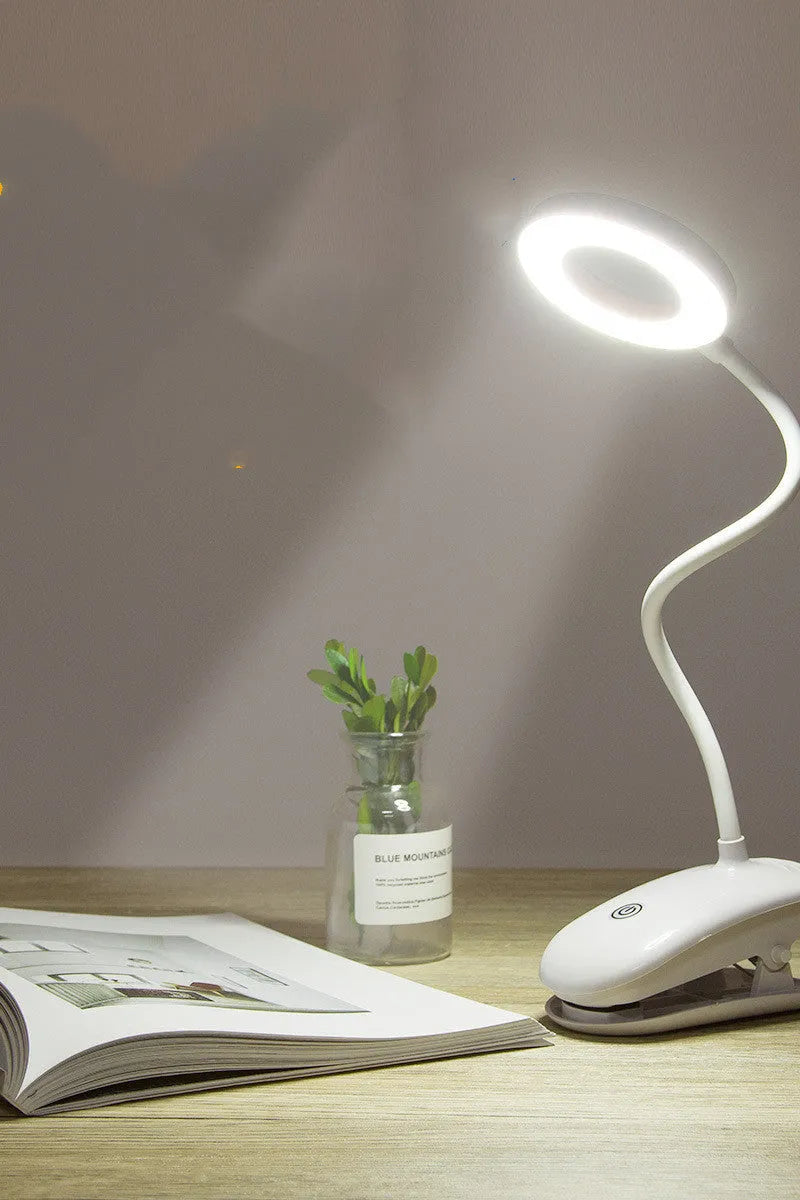 White rechargeable clip-on desk lamp with a modern plastic shade and touch switch