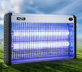 Blue plastic electric mosquito killing lamp with UV lights and fan, hanging from a wall for indoor insect control.