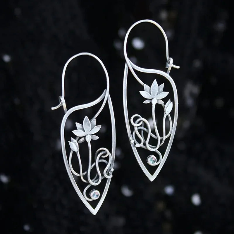 Silver geometric lotus vine earrings with rhinestone accents on white background