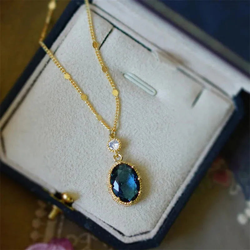 Gold geometric pendant necklace with French retro style on a model.