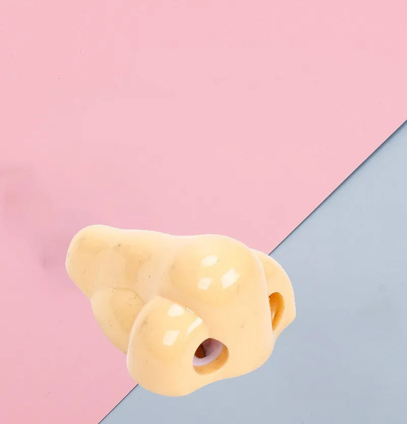 Flesh colour geometry-shaped plastic pencil sharpener for manual use.