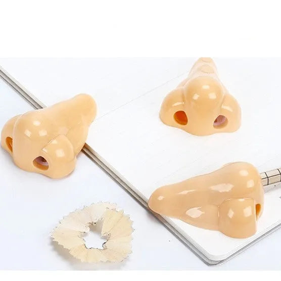 Flesh colour geometry-shaped plastic pencil sharpener for manual use.