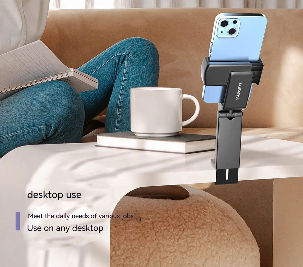A foldable black phone holder with a rotating head, shown holding a smartphone.
