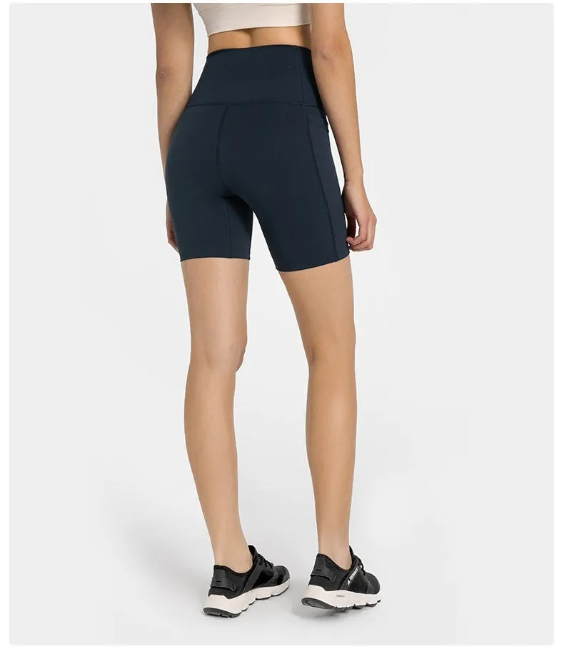 Solid colour women's sports shorts in a fifth pants length with a tight fit.