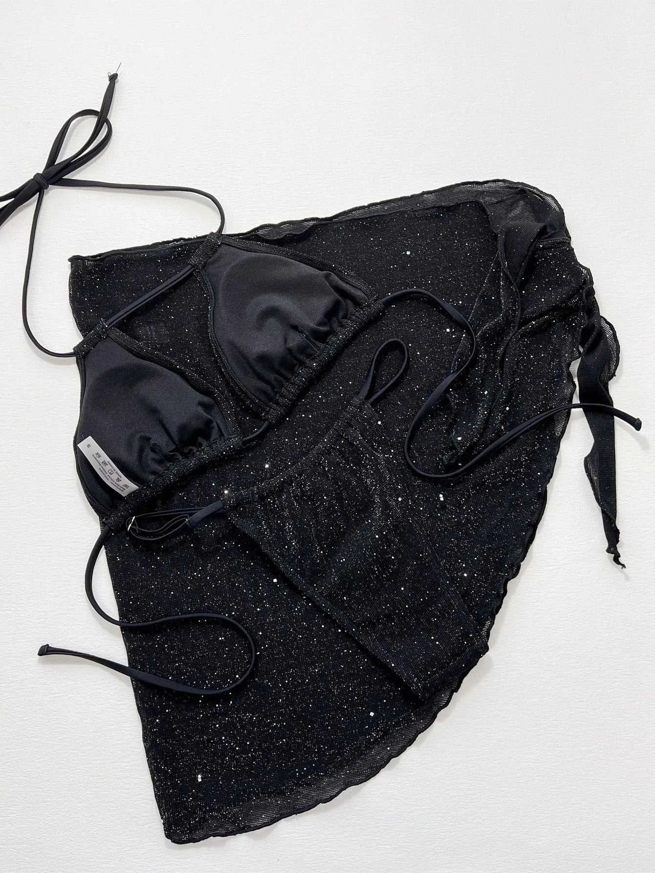 Black women's three-piece fission bikini set with top and shorts on a mannequin.