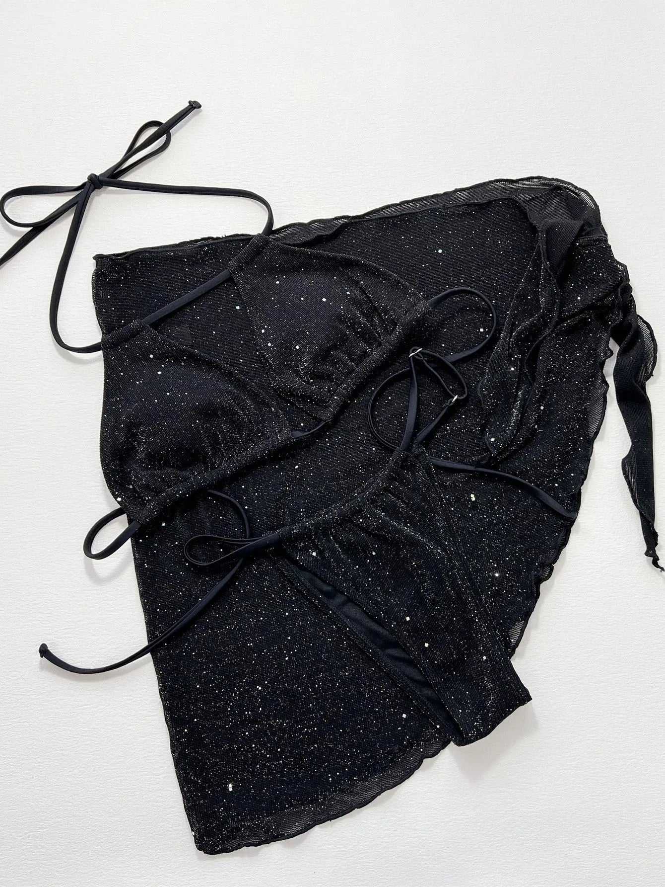 Black women's three-piece fission bikini set with top and shorts on a mannequin.