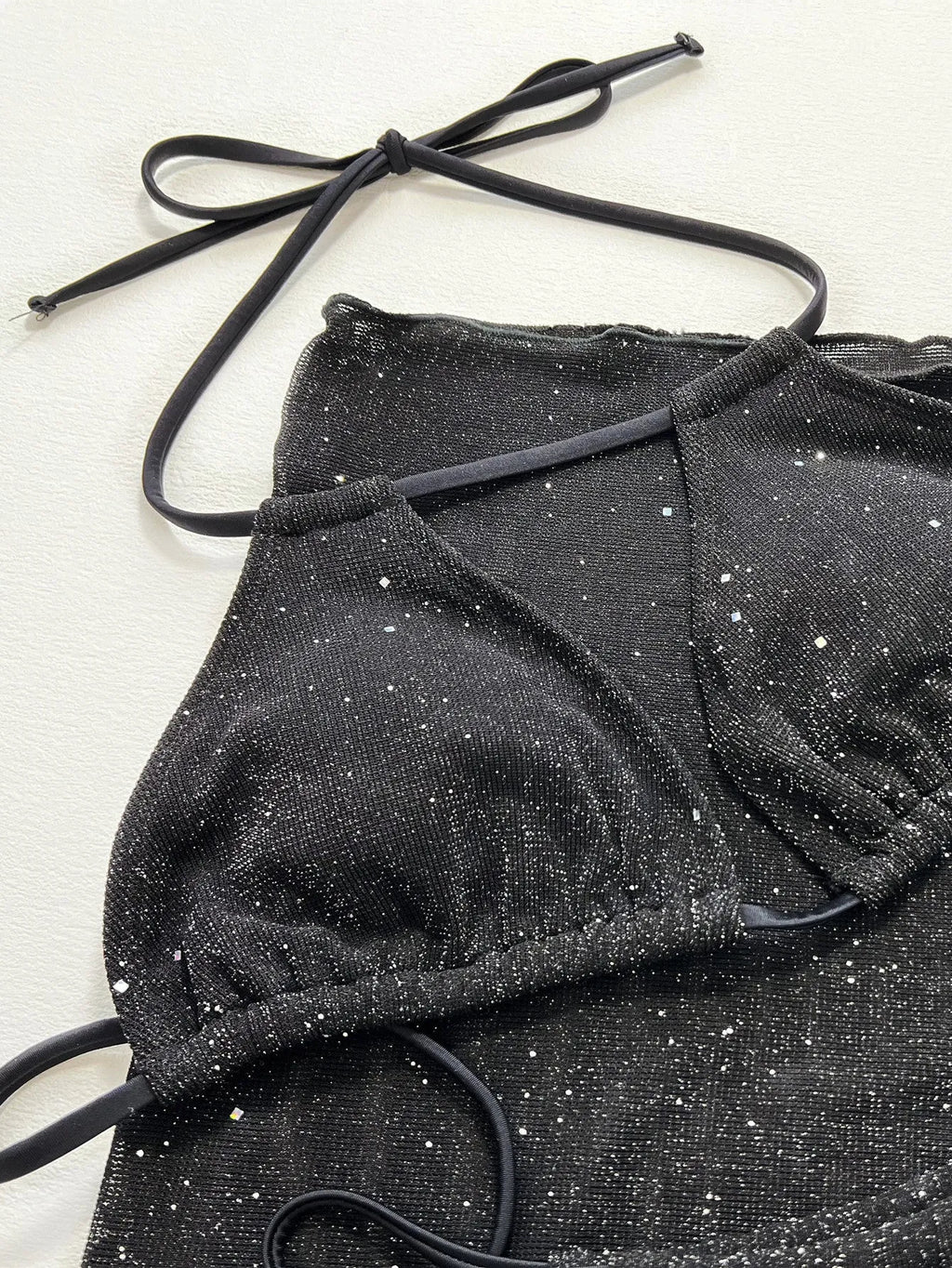 Black women's three-piece fission bikini set with top and shorts on a mannequin.