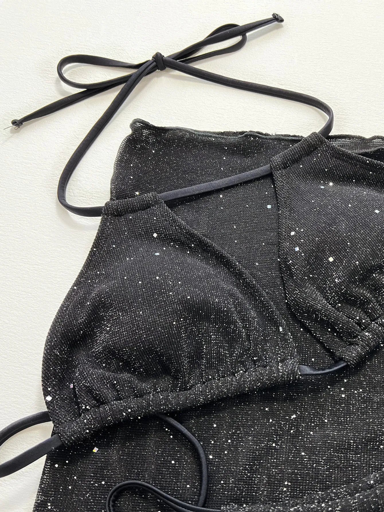 Black women's three-piece fission bikini set with top and shorts on a mannequin.