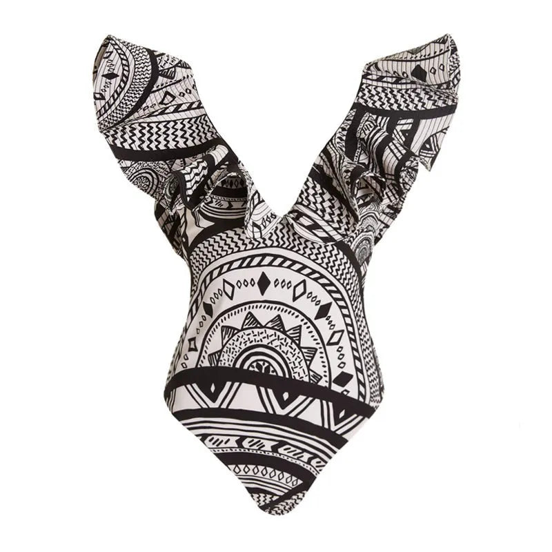 Women's vintage printed deep V-neck one-piece swimsuit with a matching wrap skirt laid flat.