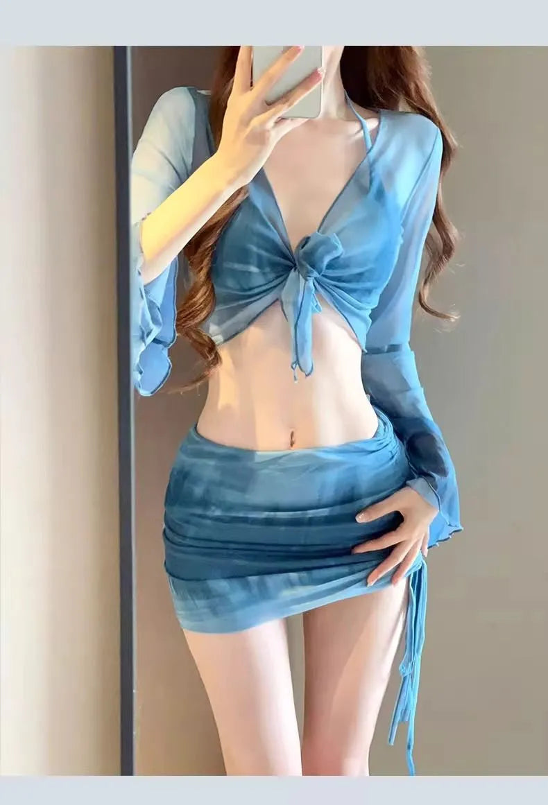 Women's blue high-waisted bikini four-piece swimsuit set with shirt, bra, underwear, and skirt for beach wear