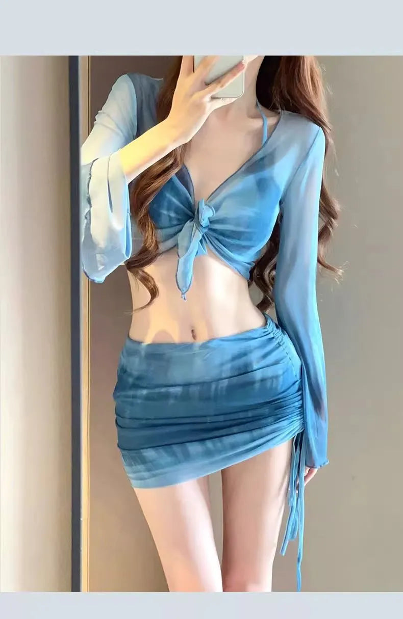 Women's blue high-waisted bikini four-piece swimsuit set with shirt, bra, underwear, and skirt for beach wear