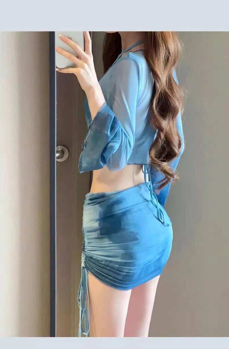 Women's blue high-waisted bikini four-piece swimsuit set with shirt, bra, underwear, and skirt for beach wear