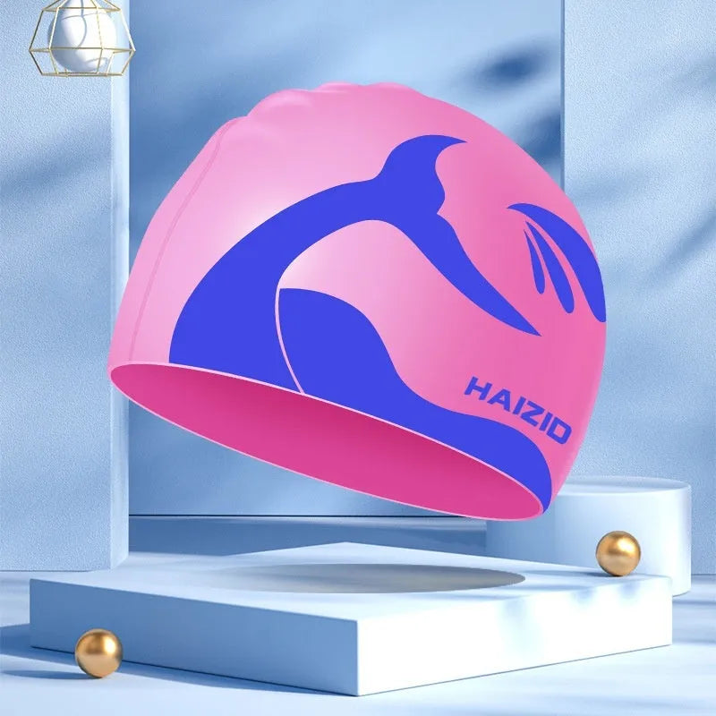 Silicone swimming cap with waterproof ear protectors showing whale tail pattern in assorted colours