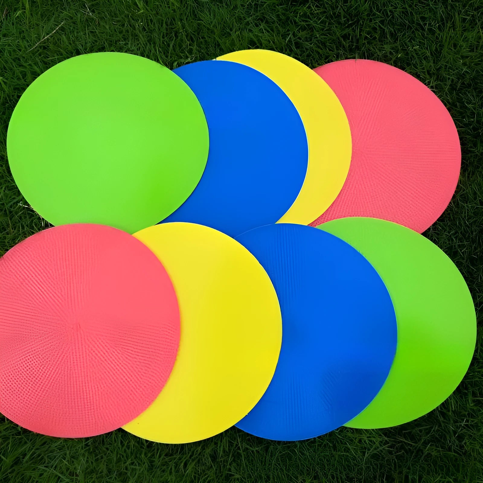 Yellow football training marker disc on grass field showing 23cm diameter flat design