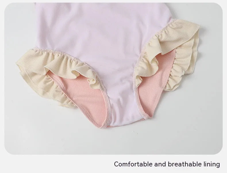 Pink women's conservative one-piece swimsuit with a Siamese design detail on a mannequin.