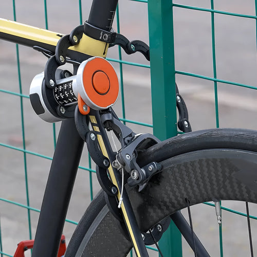 A black and orange portable bicycle folding lock shown in its compact, folded form.
