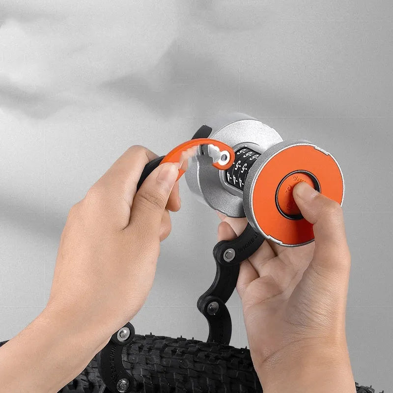 A black and orange portable bicycle folding lock shown in its compact, folded form.