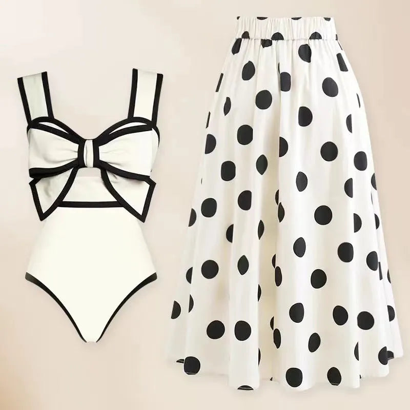 Women's black and white one-piece swimsuit with round skirt and bow detail
