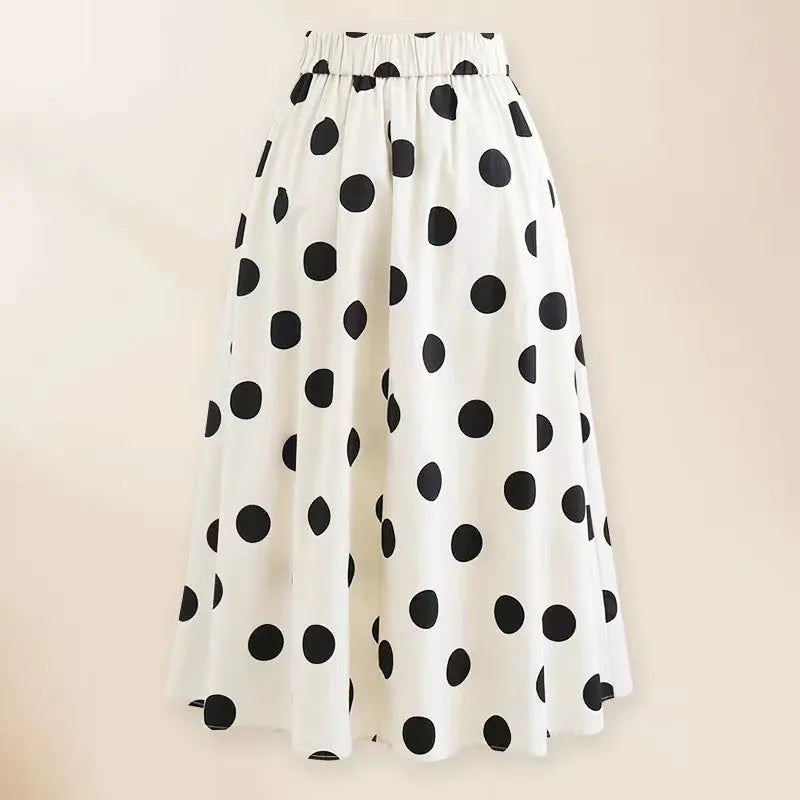 Women's black and white one-piece swimsuit with round skirt and bow detail