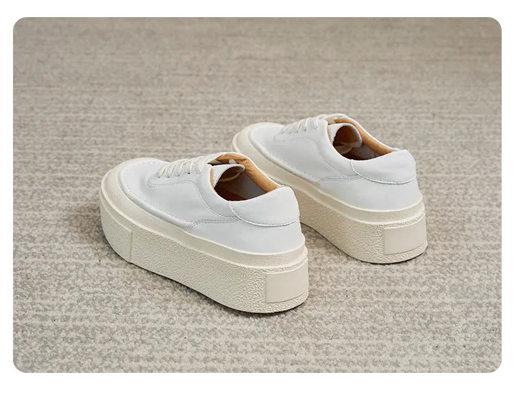 Women's black platform trainers with embossed leather upper and rubber sole