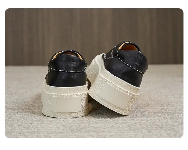 Women's black platform trainers with embossed leather upper and rubber sole