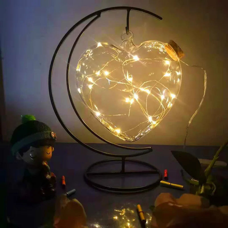 Round glass wish bottle with cork, 12 cm diameter, containing a warm white LED light strand with 20 lamp beads and folded paper stars