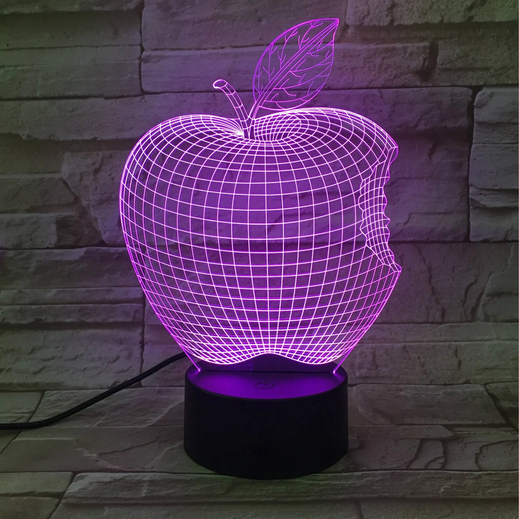 3D fruit-shaped colourful acrylic night light with touch control on a dark surface.